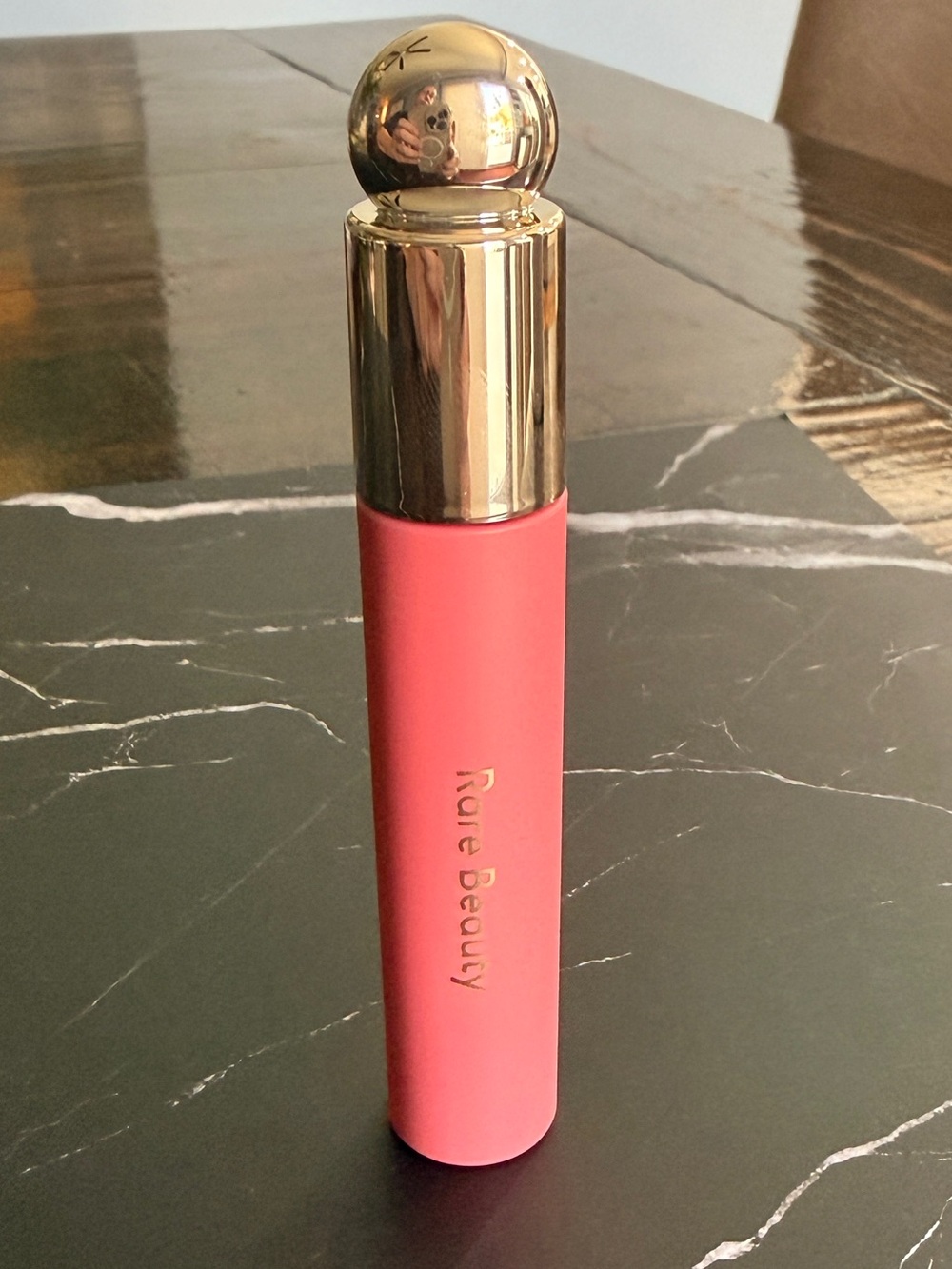 Rare Beauty Soft Pinch Tinted Lip Oil in Hope, a flattering nude-mauve shade.